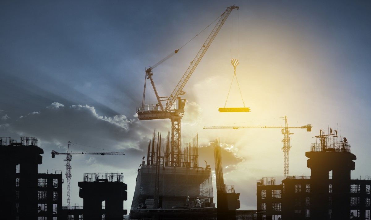 big crane and building construction against beautiful dusky sky use for construction industry and engineering